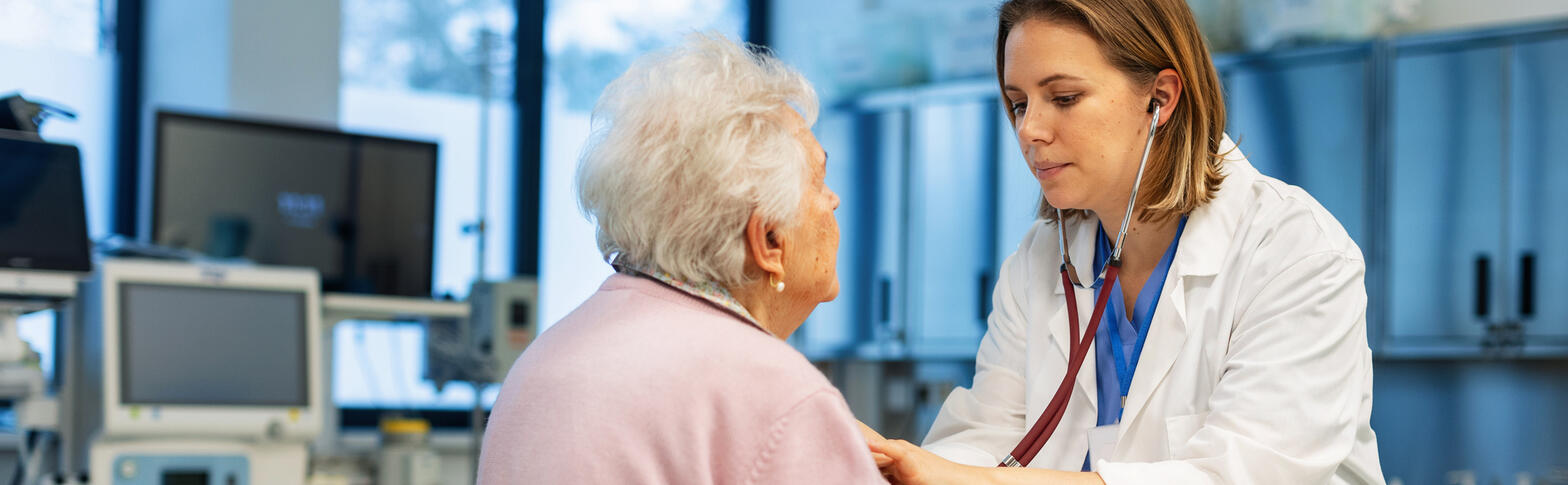 doctor examining older patient