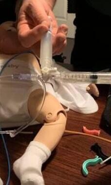 EMS providers practicing skills on pediatric mannequin