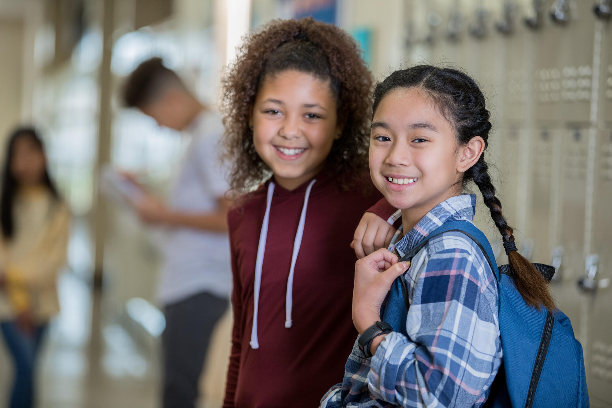 two middle school students by lockers