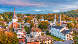 Rural Vermont town with a number of buildings in a fall mountain setting.