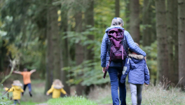 Woman and children walking through the woods