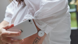 Adult scanning a diabetes port with their phone