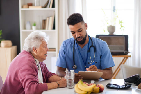 A nurse assisting an older patient