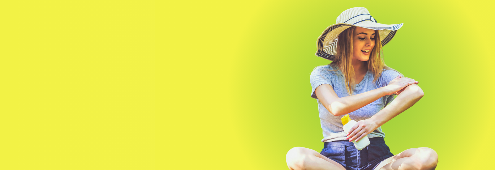 Woman wearing a sunhat and putting on sunscreen.