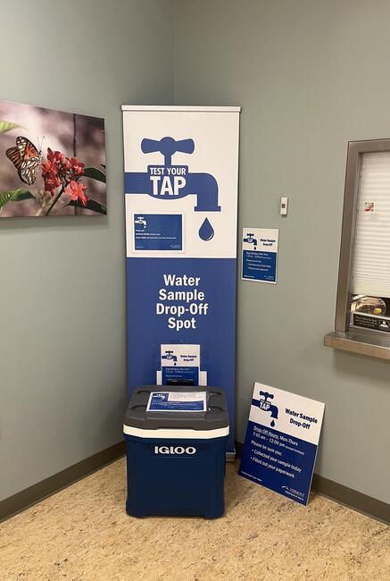 Water Drop Off Program banner and cooler in a district office